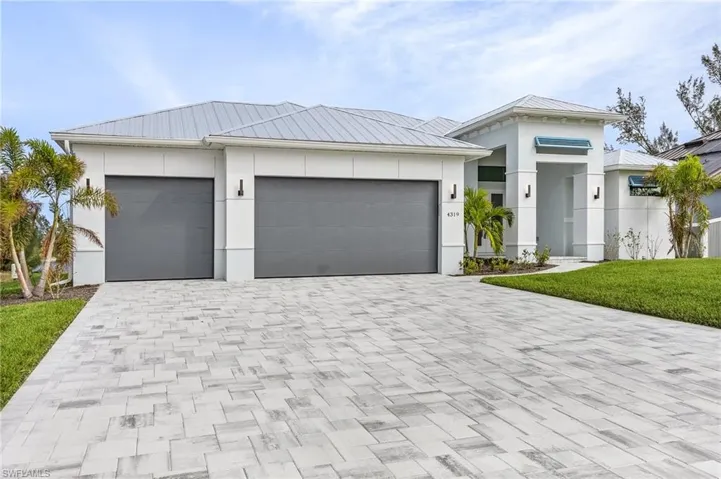 View of front of house featuring a front yard and a garage