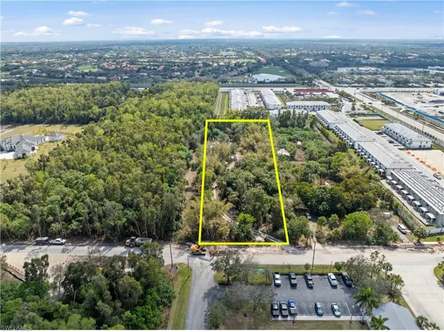 Aerial view of property and surrounding area with property parcel outlined