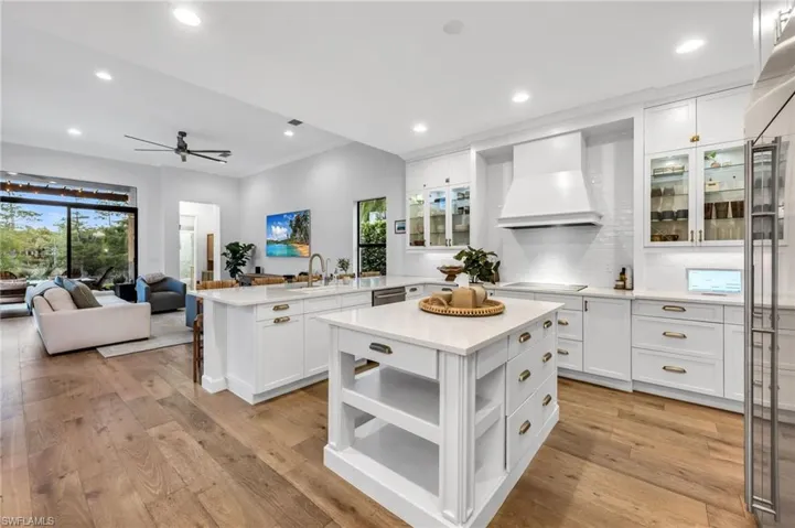 Modern kitchen featuring white cabinetry, a large kitchen island, and wood-finish flooring