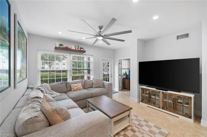 Living area with recessed lighting and ceiling fan