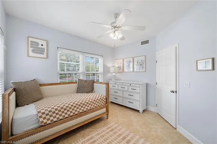 Bedroom featuring ceiling fan and light tile patterned flooring
