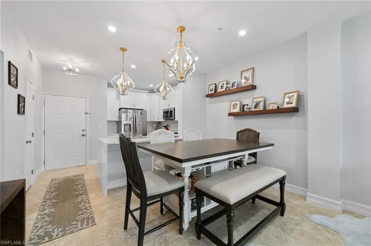 Dining room with suspended lighting and baseboards