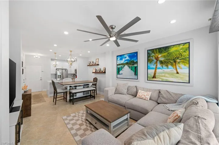Living area featuring suspended lighting and ceiling fan
