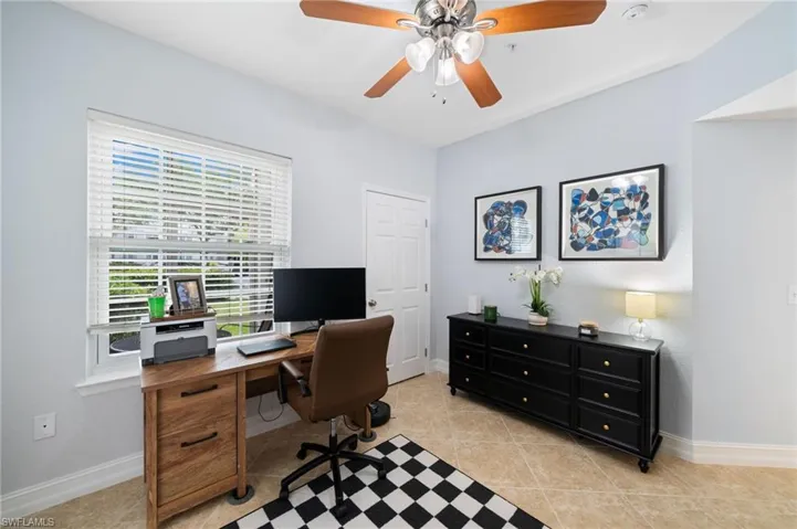 Office space featuring light tile patterned flooring and a ceiling fan