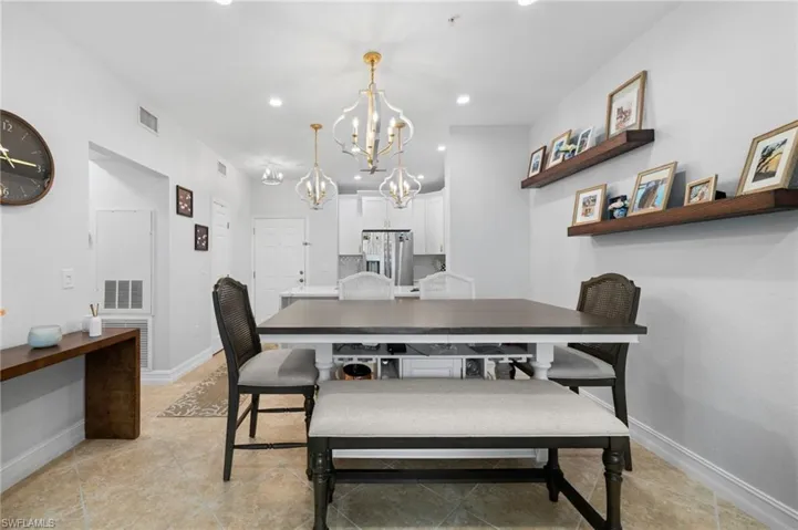 Dining room featuring a chandelier and baseboards
