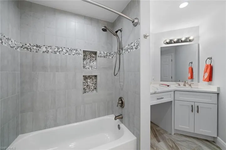 Full bath featuring vanity and bathing tub / shower combination