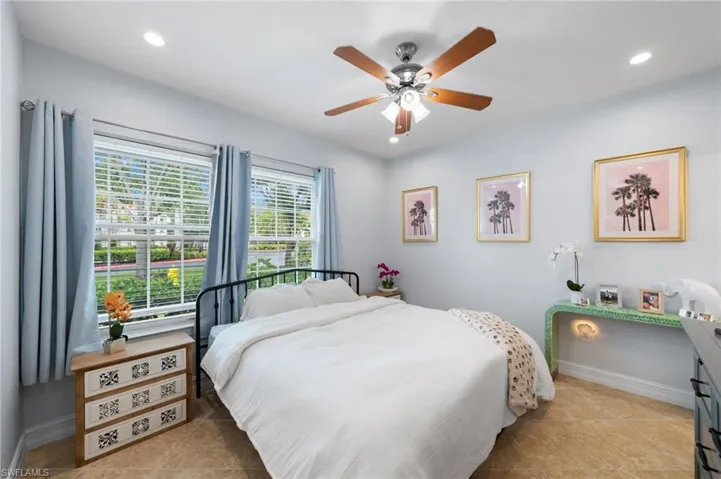 Bedroom with a ceiling fan, recessed lighting, and light tile patterned flooring