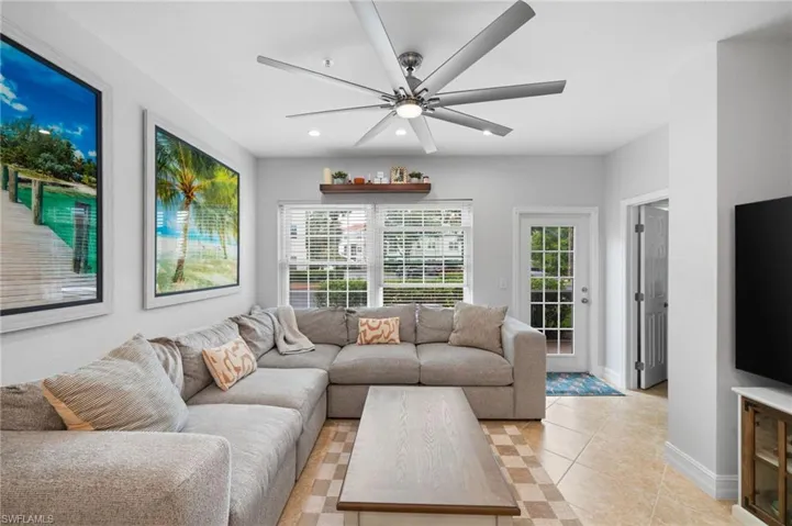 Living area with ceiling fan, recessed lighting, and light tile patterned flooring
