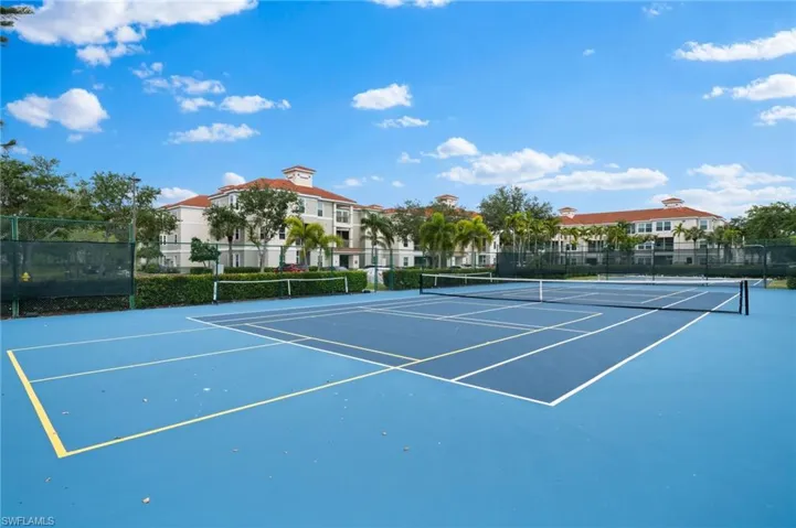 View of tennis court featuring community basketball court