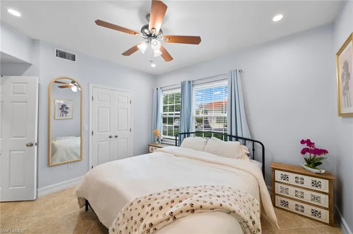Bedroom with recessed lighting, a closet, a ceiling fan, and light tile patterned floors