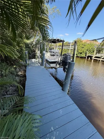 View of dock with a water view and boat lift
