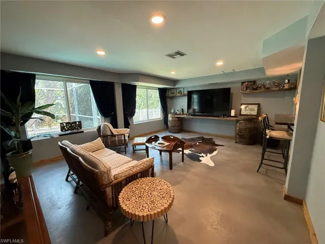 Living area with baseboards, recessed lighting, and visible vents
