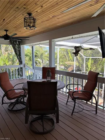 Sunroom featuring a healthy amount of sunlight, outdoor dining area, and ceiling fan