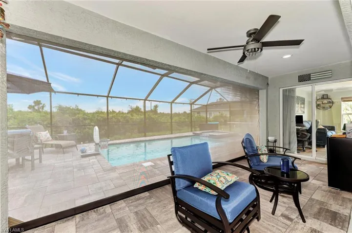 Sunroom featuring ceiling fan