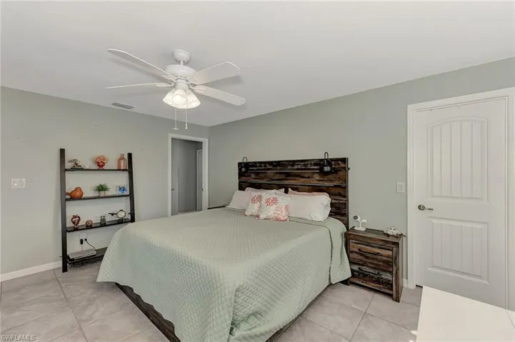 Bedroom featuring light tile patterned flooring and ceiling fan