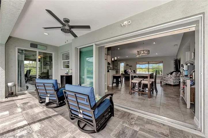 View of patio featuring an outdoor hangout area and ceiling fan
