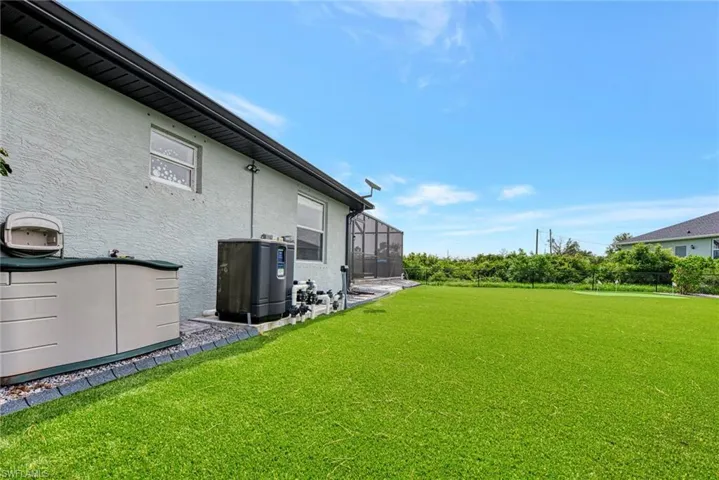 View of yard featuring glass enclosure
