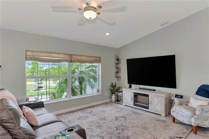 Living room with vaulted ceiling and ceiling fan