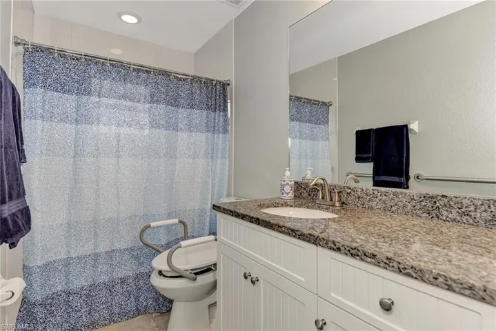Bathroom with vanity, tile patterned flooring, and toilet