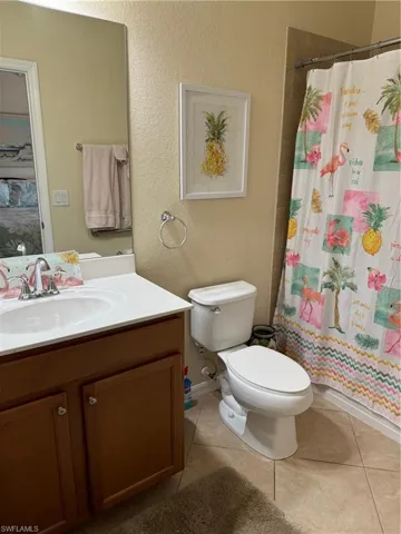 Bathroom featuring tile floors, toilet, and vanity