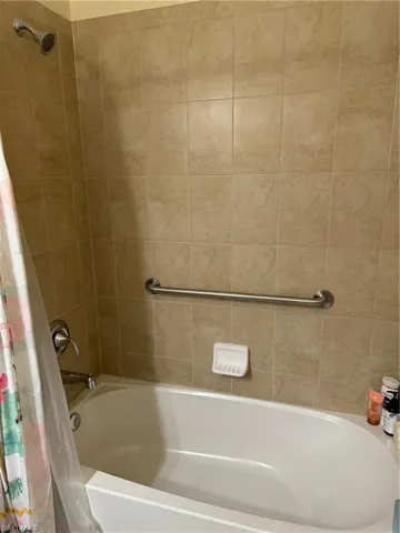 Bathroom featuring shower / bath combo with shower curtain