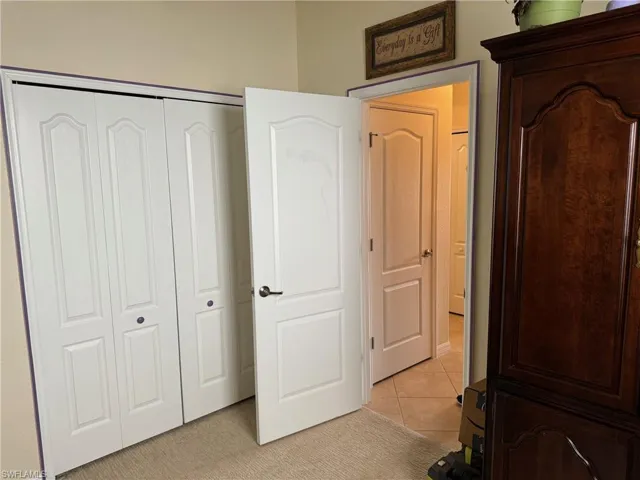 Unfurnished  guest bedroom 3 featuring a closet and light colored carpet