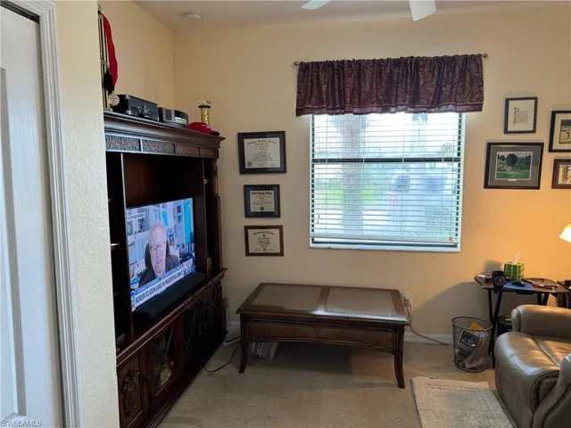 Guest bedroom 2 featuring carpet flooring and ceiling fan