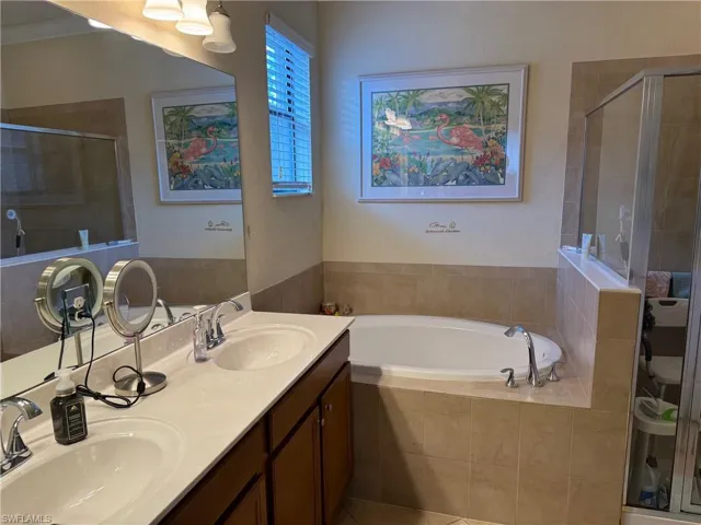 PrimarybBathroom with double vanity and plus walk in shower