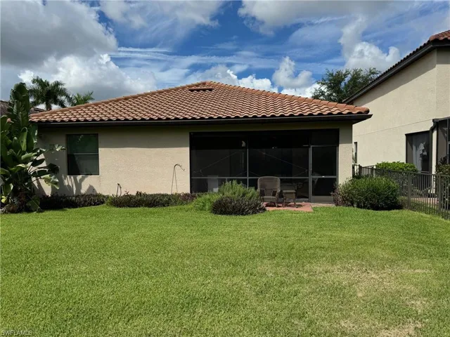 Back of property featuring a yard