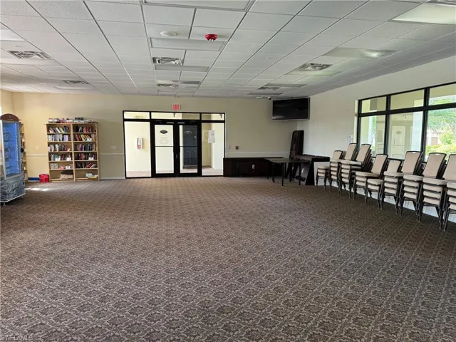 Clubhouse room featuring carpet floors and a paneled ceiling
