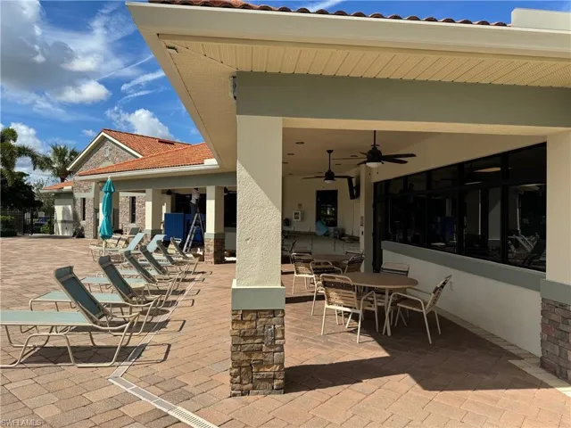 View of pool terrace featuring ceiling fan
