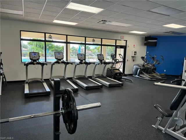 Exercise room with plenty of natural light and a drop ceiling