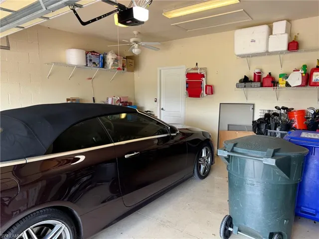 Garage with a garage door opener and ceiling fan