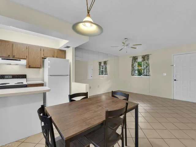 Dining room featuring light tile patterned floors and ceiling fan