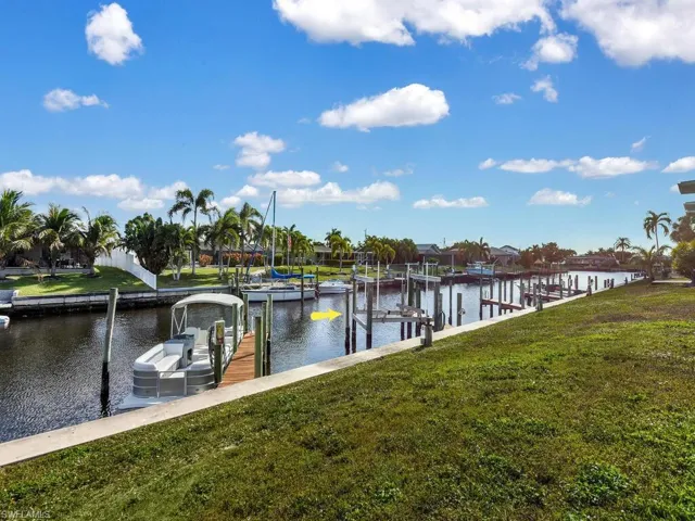 Dock area with a yard, a water view, and boat lift