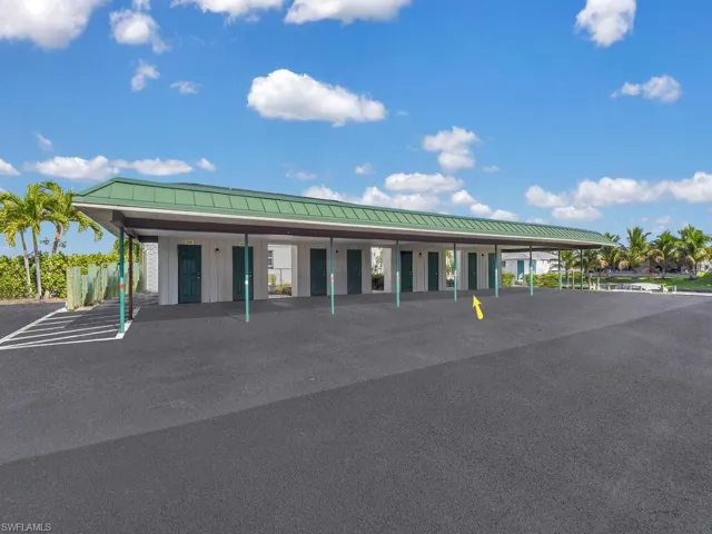 View of building exterior with covered parking