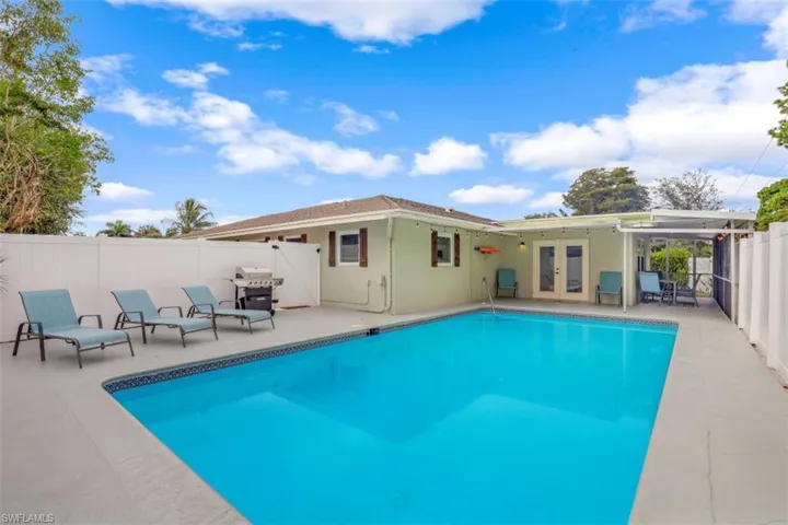 View of swimming pool with a grill, french doors, and a patio area