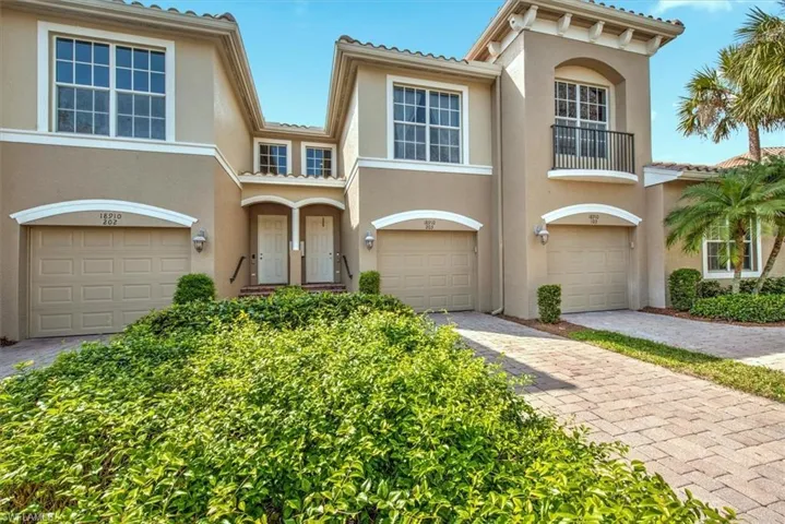 Mediterranean-style townhouse with stucco exterior and barrel tile roofing