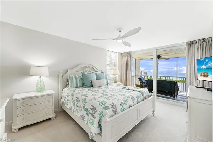 King bed in Primary Bedroom/ sliders open to screened patio