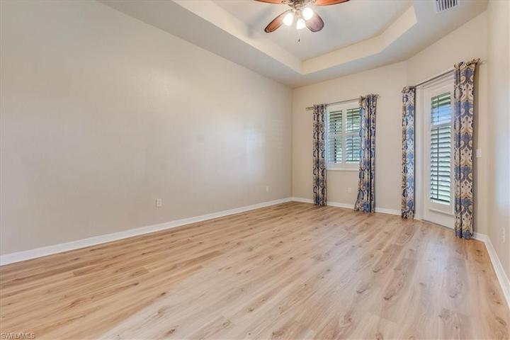 Primary Bedroom with door to screened in lanai