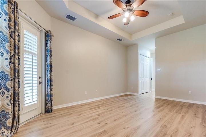 Primary Bedroom with door to screened in lanai