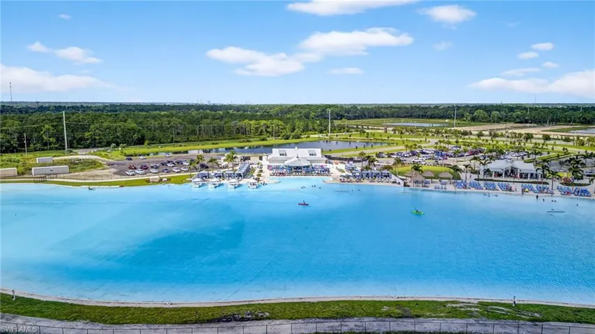 Drone / aerial view of a heavily wooded area and a large body of water