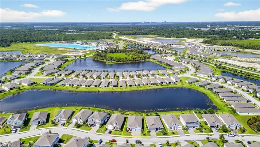 Aerial view of residential area featuring a large body of water