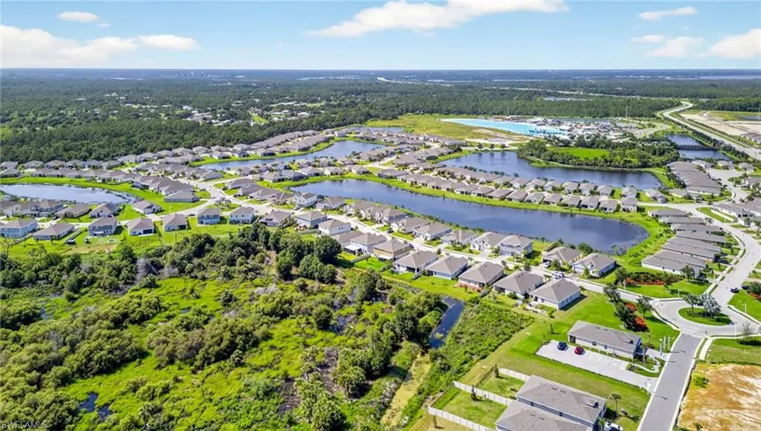 Aerial perspective of suburban area featuring a large body of water