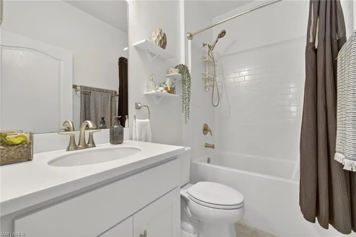 Hall featuring light tile patterned floors and recessed lighting