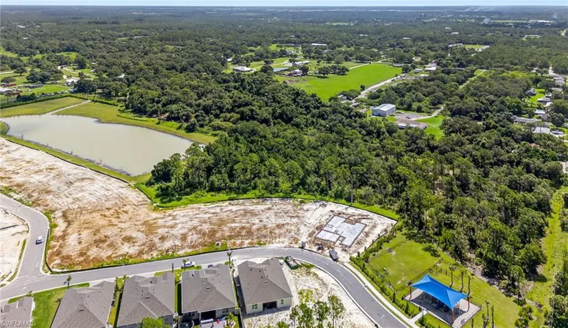 Single story home featuring a residential view, an attached garage, a water view, and driveway