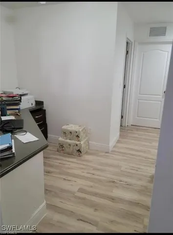 Office featuring light wood-style floors and baseboards