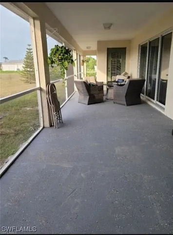 View of patio with a sunroom and outdoor lounge area