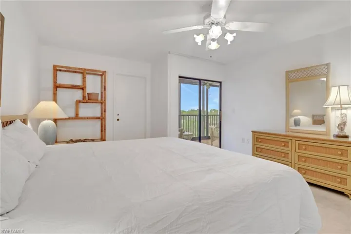 Bedroom with access to exterior and a ceiling fan