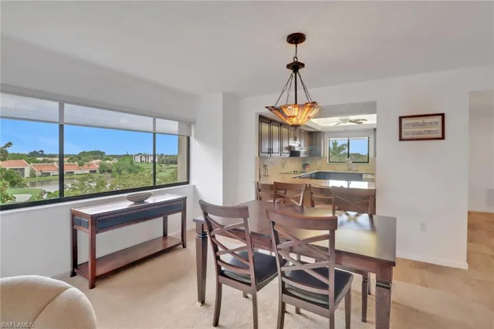 Dining room with a ceiling fan and baseboards